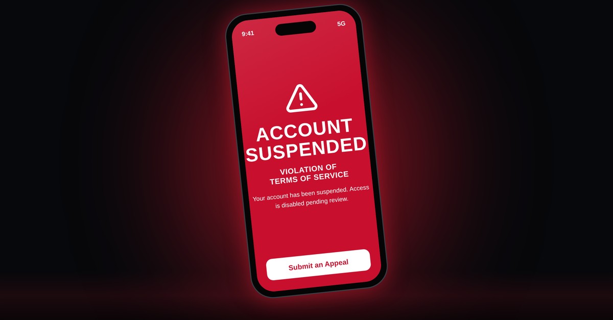 Phone screen showing an account suspended notice for a terms of service violation